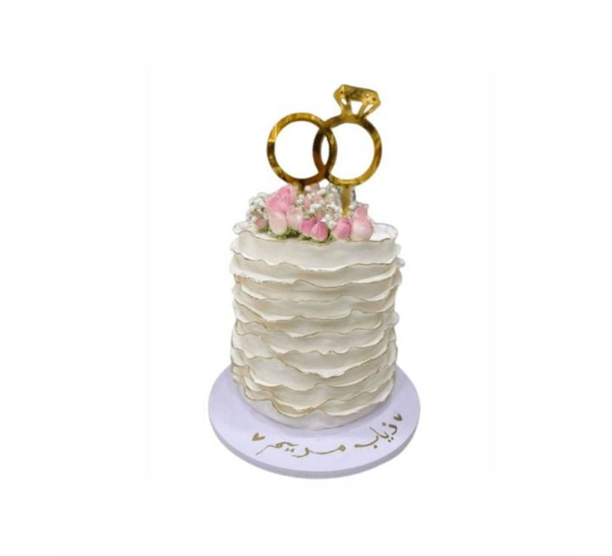 White Ombre Wedding Cake with Pink Flowers & Gold Ring Topper – Elegant Engagement Cake | Abu Dhabi & UAE Delivery in Abu Dhabi | Wedding / Engagement Cakes Delivery UAE – Legrandeuae