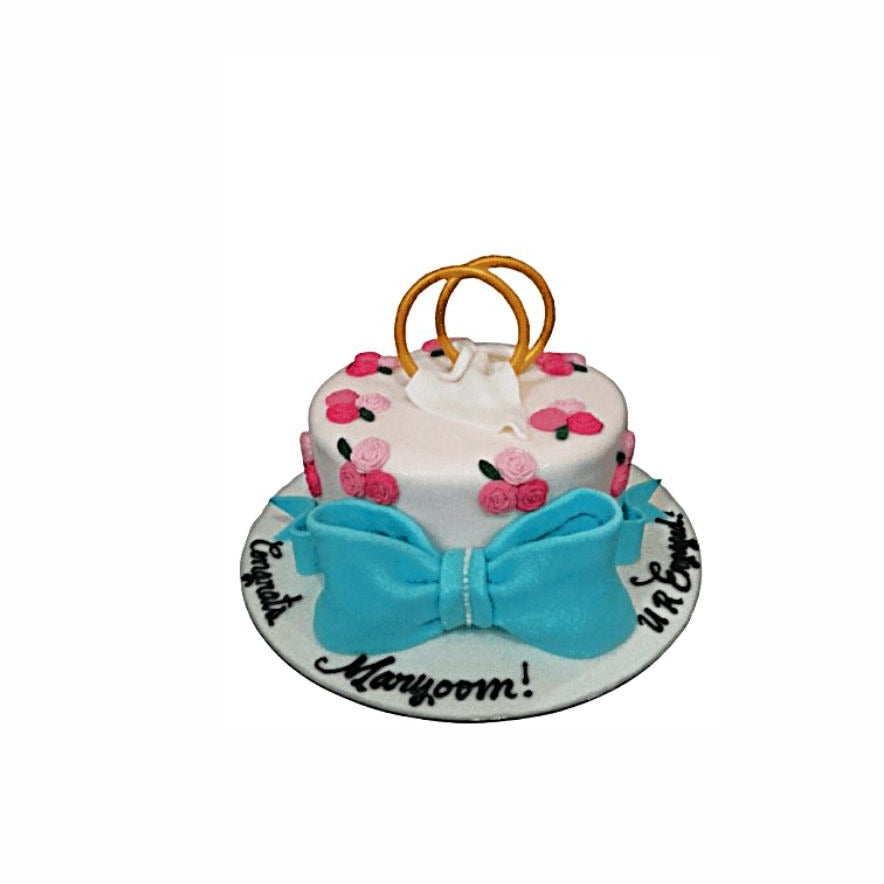Small Round Engagement Cake with Blue Bow & Gold Rings – Elegant Floral Cake | Abu Dhabi & UAE Delivery in Abu Dhabi | Wedding / Engagement Cakes Delivery UAE – Legrandeuae