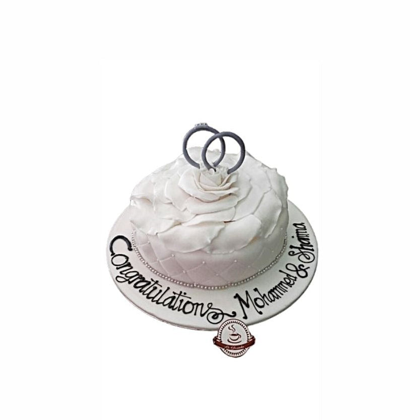 Simple White Wedding Cake with Petal Design & Ring Topper – Elegant Engagement Cake | Abu Dhabi & UAE Delivery in Abu Dhabi | Wedding / Engagement Cakes Delivery UAE – Legrandeuae