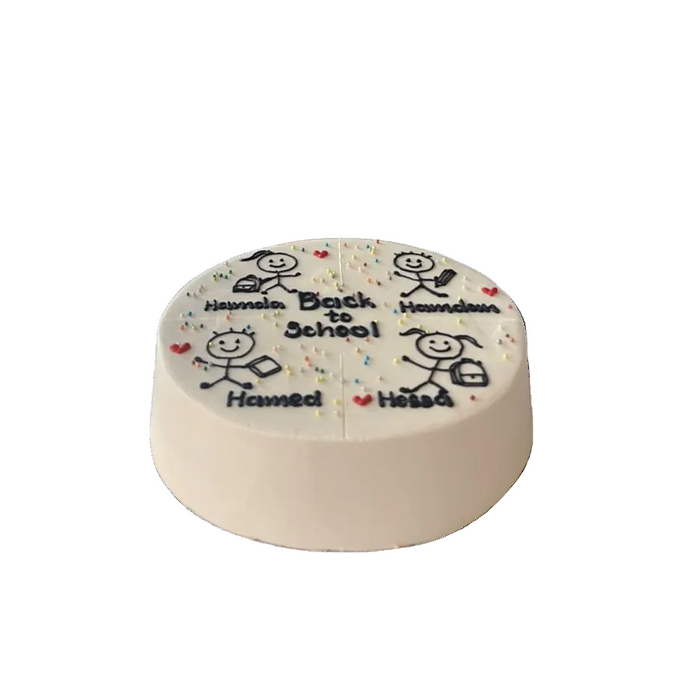 A round white frosted cake with black text reading 'Hummada Bath Is School' and 'Hummada Humsa', decorated with small red hearts, blue and red sprinkles, and simple stick-figure drawings, shown on a plain white background.