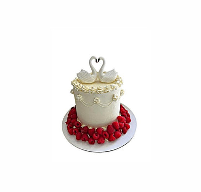 Eternal Love White Wedding Cake with Raspberries & Swan Topper – Elegant Engagement Cake | Abu Dhabi & UAE Delivery in Abu Dhabi | Wedding / Engagement Cakes Delivery UAE – Legrandeuae
