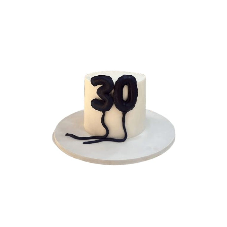 Elegant white 30th birthday cake with black number decoration on a cake stand - Abu Dhabi