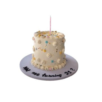 Elegant Cream Birthday Cake with Colorful Sprinkles and Pink Candle - Abu Dhabi